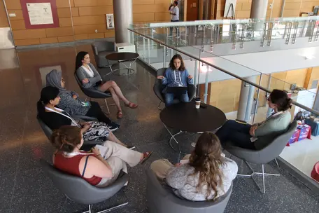 A group of people sitting around a table in discussion.