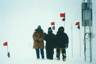 REU participant Elaine Godfrey (center) and teammates at the top of the Greenland ice cap after successfully repairing a magnetometer