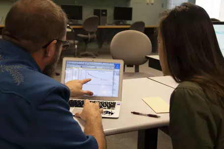 Workshop participants look at data.