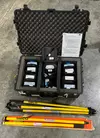 Open pelican case with five Emlid Reach RS2 receivers and survey poles in front.
