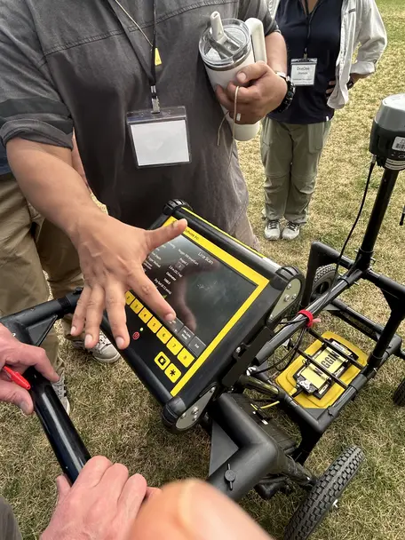 Close up of hand pointing to GPR controller screen components.