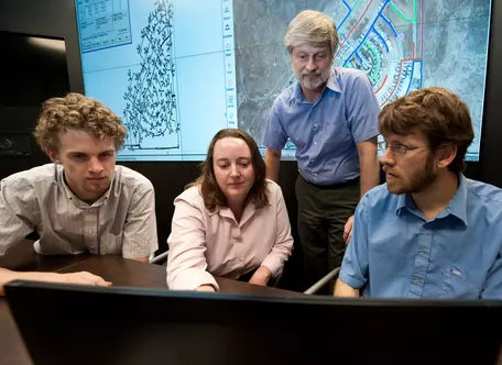 Students and NREL staff conducting at class at the Distributed Energy Systems Integration group's visualization center