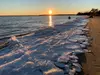 Ice on riverbank at sunset