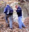 Decorative image showing students examining an outcrop.