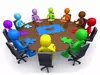 Diverse faculty meeting at a table.