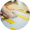 person writing on sticky notes on a poster board
