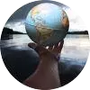 globe held in a hand above water