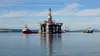 Deepwater drilling rig Ocean Valiant being towed into Cromarty Firth bay