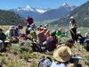 students in the field with mountains in the background
