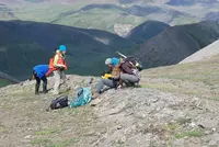 Students looking at a calcareous sandstone bed