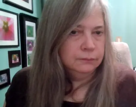 Profile photo of Kerry Vachta in front of book case.