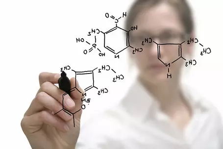 Chemical compound being drawn by female chemist.