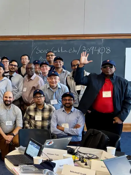 Group of workshop participants looking at the camera and waving. 